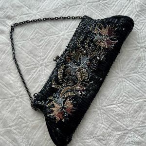 Small White House Black Market sequined black clutch with colorful floral sequin